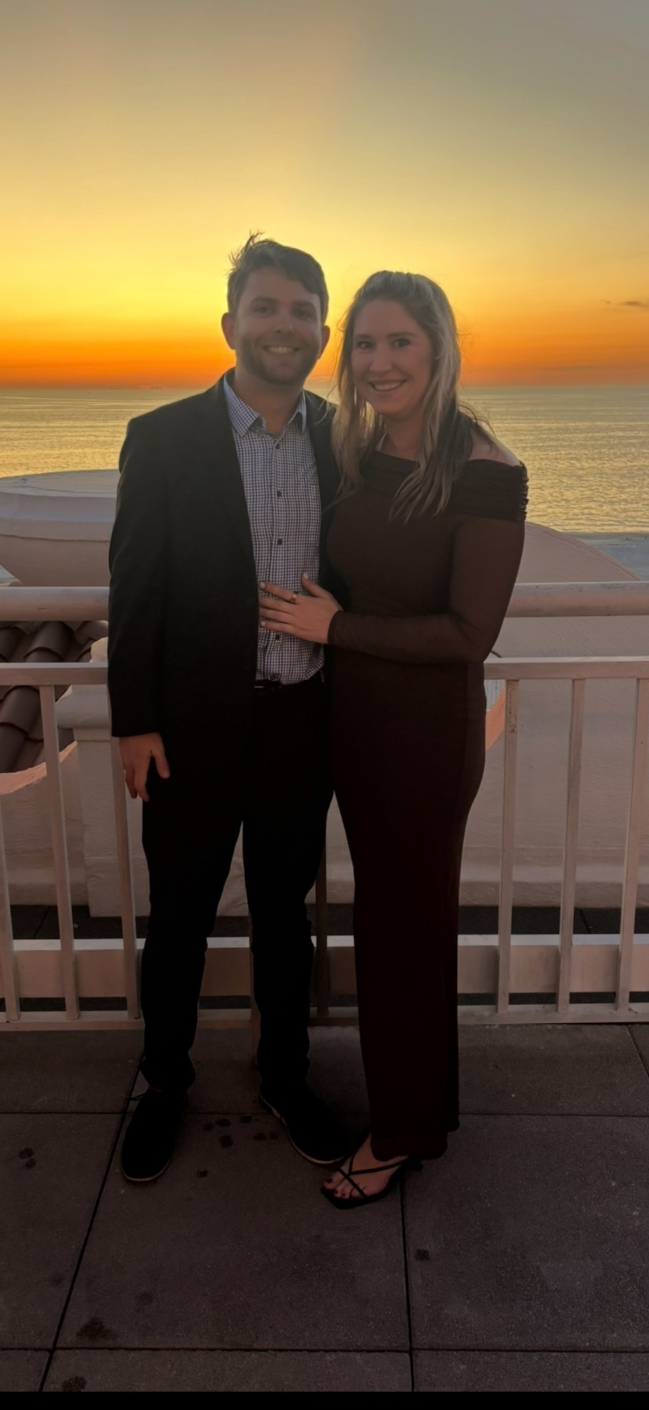Grant Messenger with his partner by the ocean at sunset
